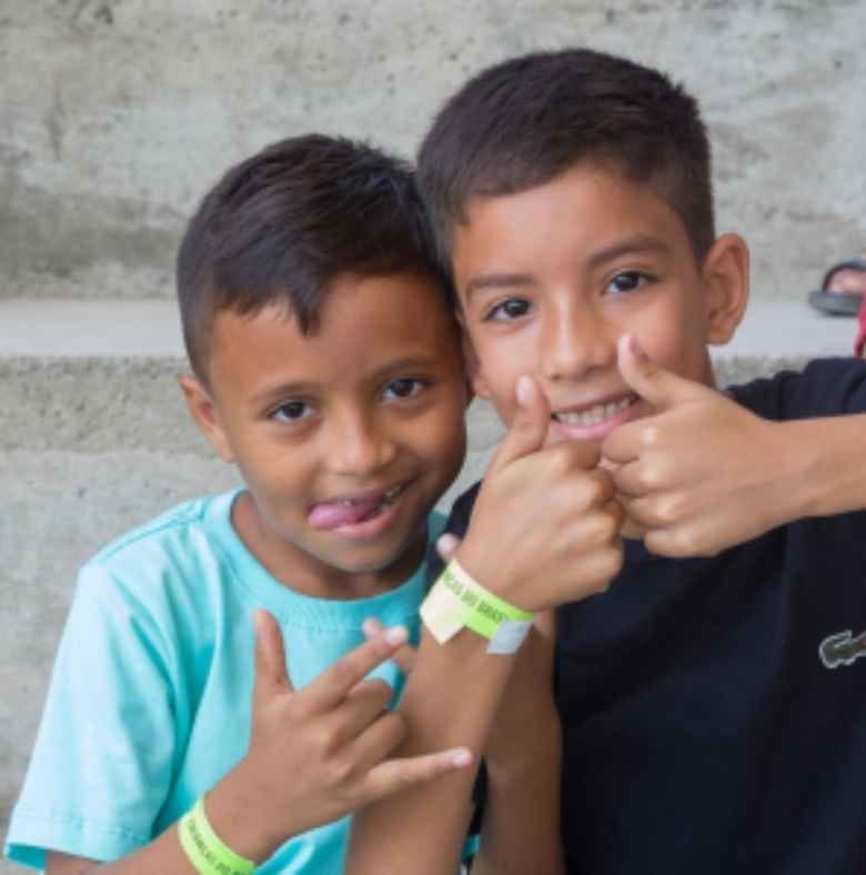 two boys giving thumbs up