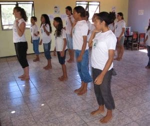 female volunteer with group of 7th graders in dance studio