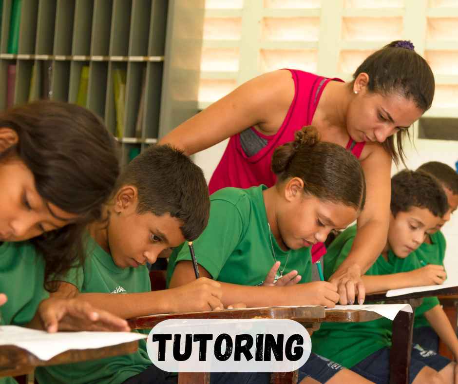 teacher helping student in classroom